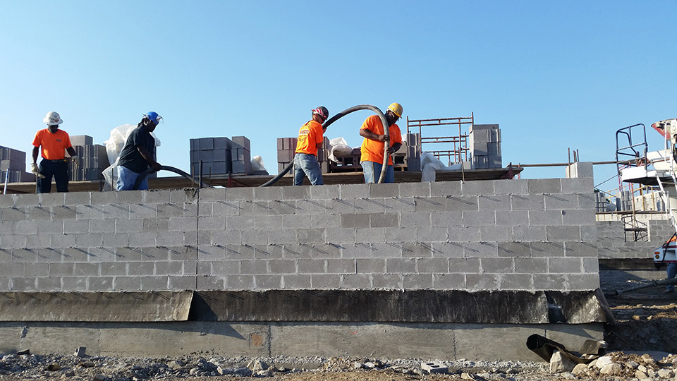 Shown is masonry wall grouting from a grout pump.