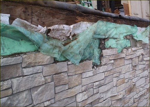 View of entrapped moisture damage to materials in a rainscreen building envelope with no drainage