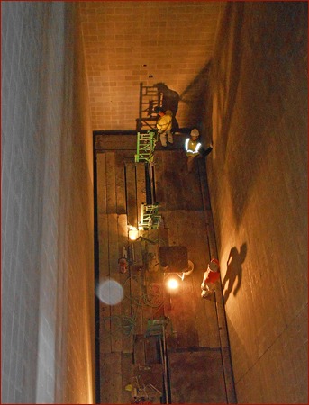 Photo 2: The walls were rubbed down as the scaffold was lowered down to the basement.