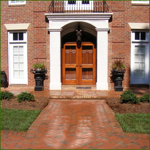 A home featuring a walkway of permeable pavers