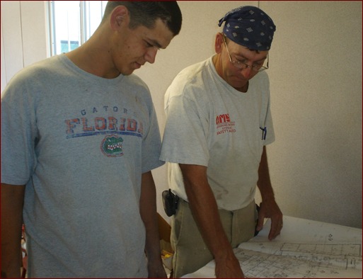 Prescott (left) and his foreman, Graduate Apprentice Brent McNett (right), review construction plans for the Crystal River High School addition in Crystal River, Fla.
