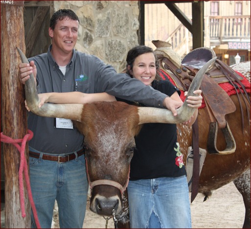 Brazos Masonry’s Zach Everett and his wife Angela, pose with Woodrow, the longhorn steer.
