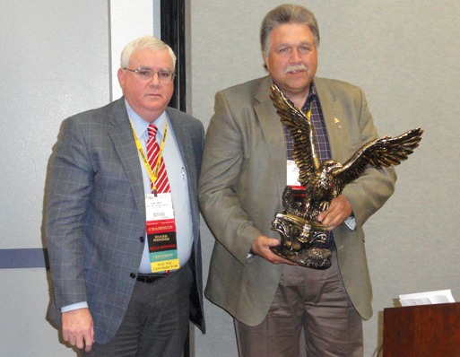 MCAA Chairman John Smith (left) presents Mackie Bounds with the C. DeWitt Brown Leadman Award.