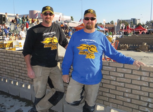 Shown are World’s Best Bricklayer Fred Campbell and his tender, Tony Shelton, in front of their brick wall.