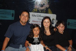 Moroni Mejia (left) from Trenwyth Industries with daughter Larianna Mejia (left, center), wife Cassie Mejia (right center), and son Lorenzo Mejia (right) get their picture taken with Mickey Mouse during the MCAA Closing dinner at the Living Seas Salon at Epcot.