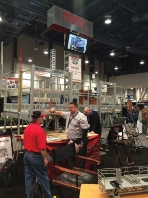 Mike Solomon (right, light-colored shirt) with Premier Scaffold has a busy week during World of Concrete/World of Masonry.