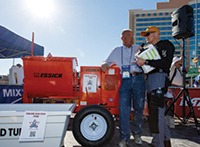 Brian Carney, of SPEC MIX, interviewing Rolly Cox on a Multiquip auction item, the Essick EM70SH8 Mortar Mixer