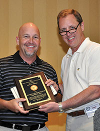  Mike Cook, company safety director, accepts the award from John Cramer on behalf of Gates Construction Co. in Mooresville.