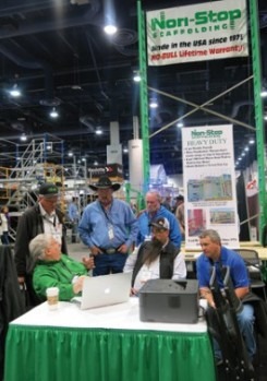 Justin Breithaupt (green shirt) gathered a crowd at his booth to discuss the benefits of using Non-Stop Scaffolding.