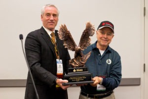 MCAA Chairman Mark Kemp (left) presents Charles Newsome (right) with the C. DeWitt Brown Leadman Award. (Photo credit: Justin Leyba)