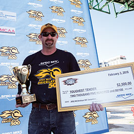 SPEC MIX TOUGHEST TENDER winner Tony Shelton on the winners stand with check and trophy.